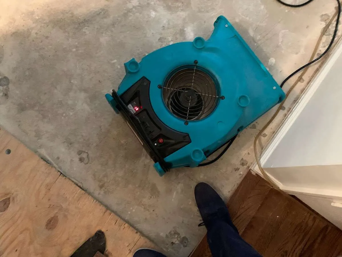 Air mover drying subfloor during Commercial Water Damage Restoration in Webb City